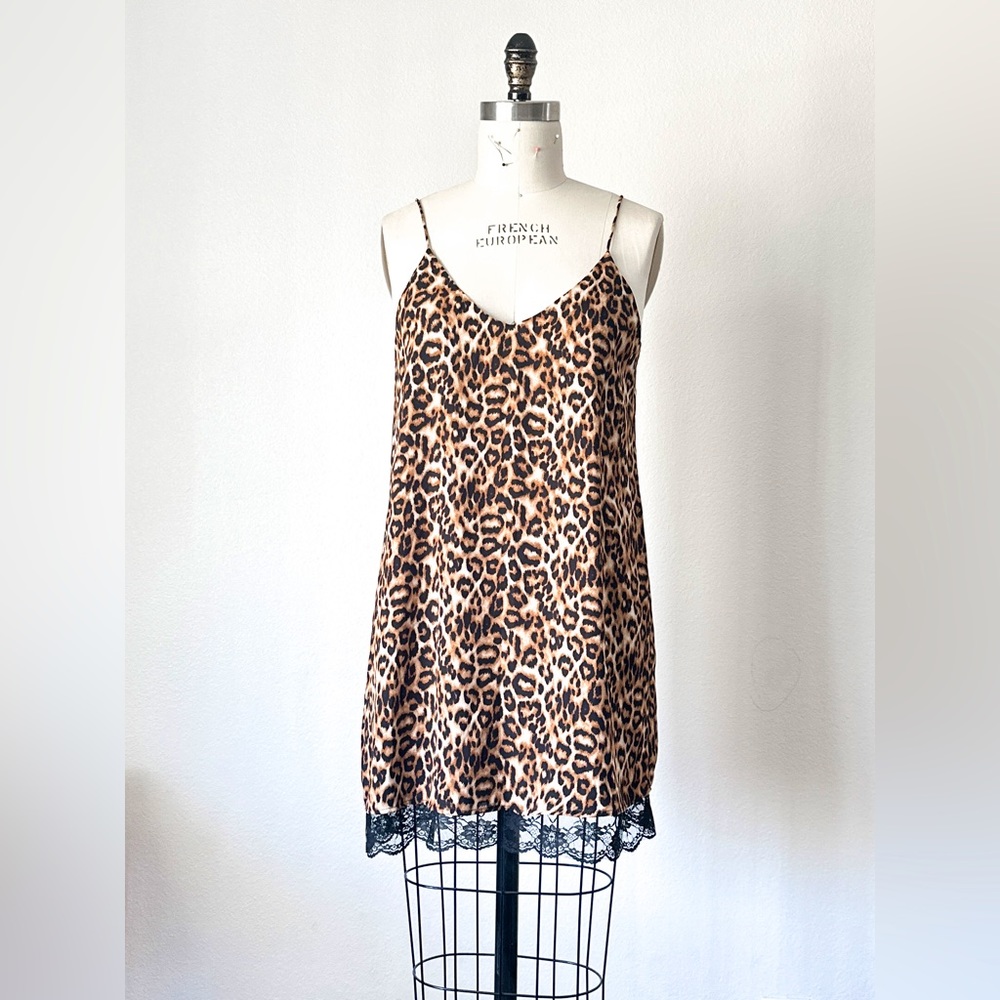 Leopard print chiffon dress with black lace trim.